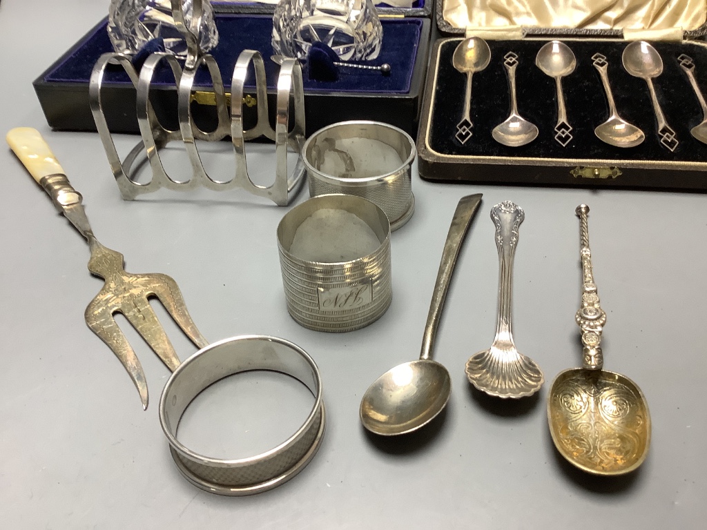 Three cased sets including silver teaspoons, a silver toast rack, three silver napkin rings and a quantity of minor silver flatware.